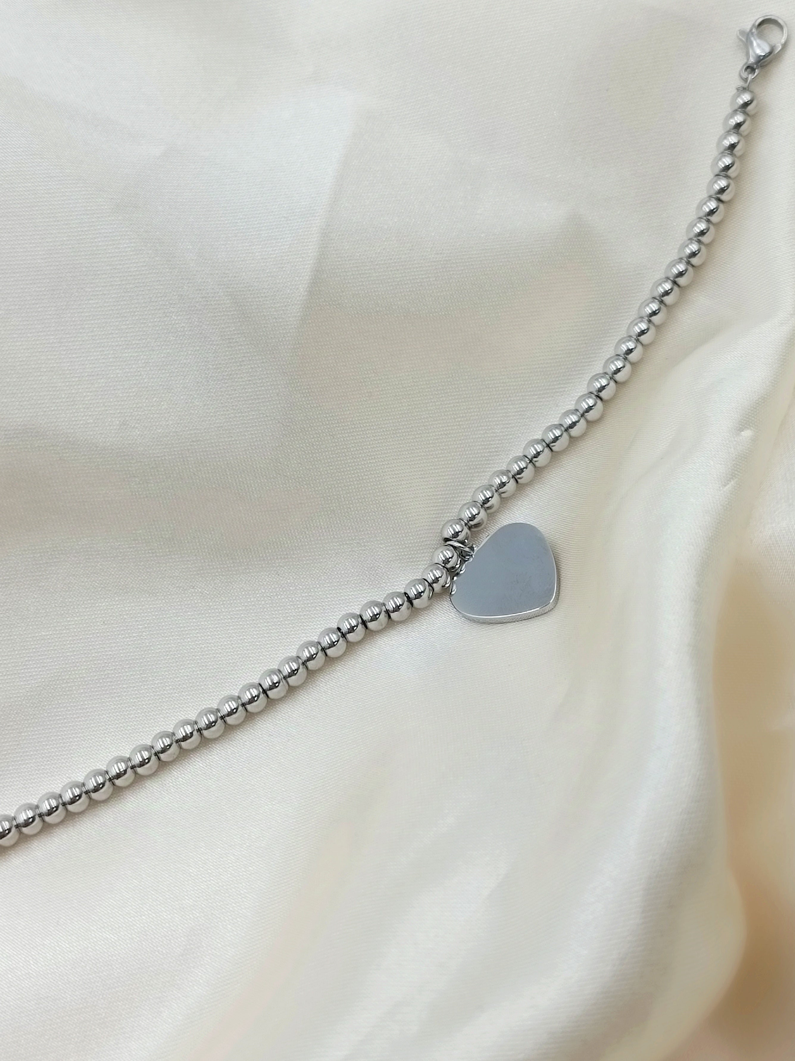 bracciale palline e cuore in acciaio